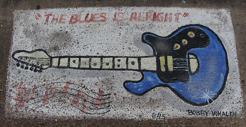 Bobby painted this small blues mural on a Church Street sidewalk. The mural is located next door to the Blues Corner Cafe. Church Street was the site of a vibrant blues scene throughout the 20th century. Photo by Maria Zeringue.